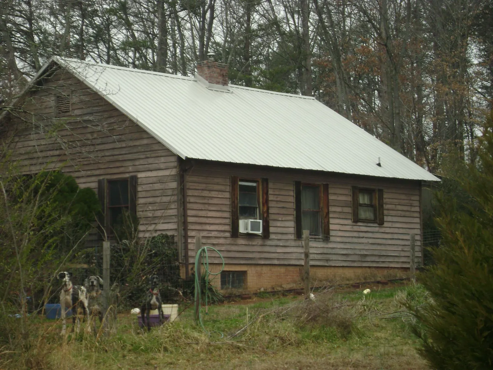 White metal roof on an old wood sided farmhouse, from a Metal Roof Installation job in Goodfield